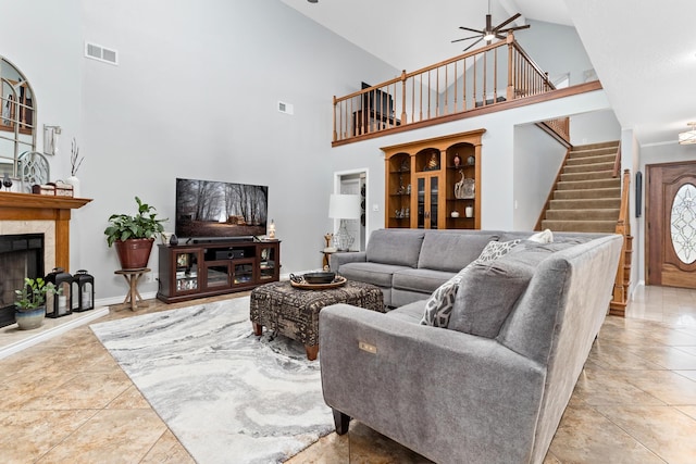 living room with ceiling fan, high vaulted ceiling, and light tile patterned flooring