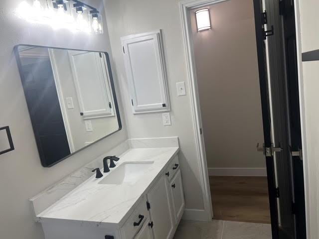 bathroom featuring tile patterned flooring and vanity