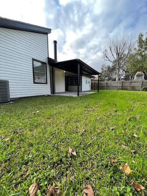 view of yard featuring a patio area and central air condition unit