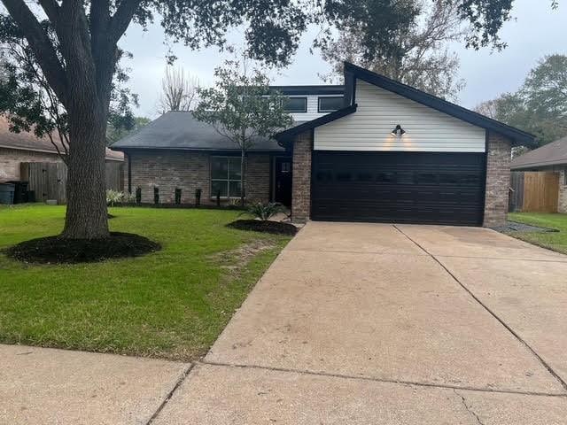 view of front of home with a front lawn and a garage