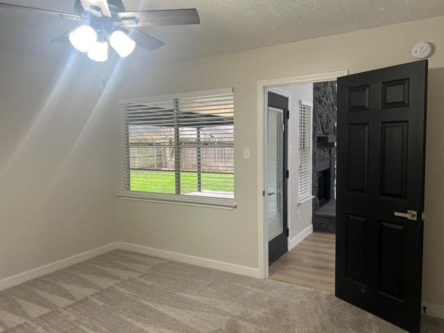 spare room with light carpet and ceiling fan