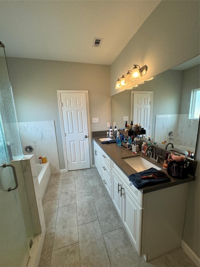 bathroom featuring tile patterned floors, vanity, and plus walk in shower