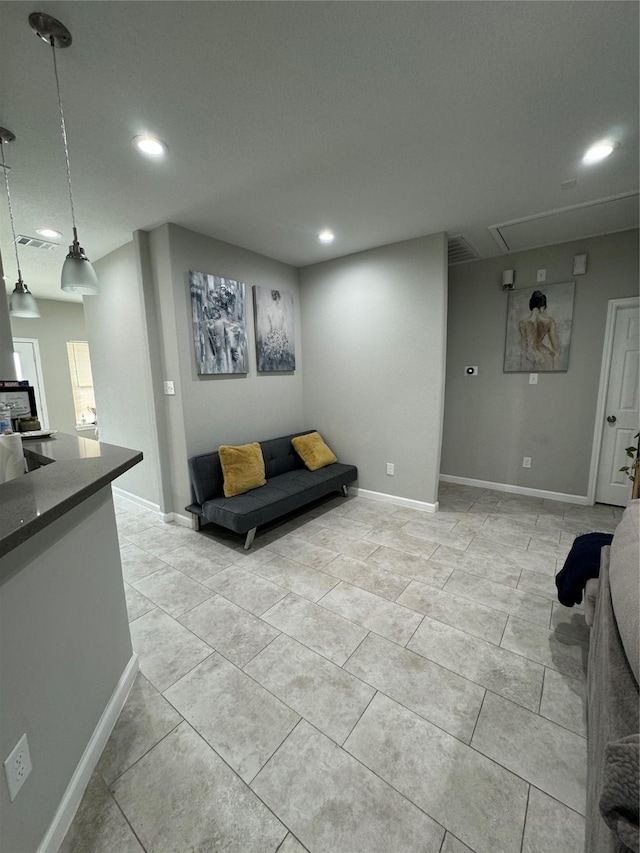 living room with recessed lighting, visible vents, baseboards, and attic access
