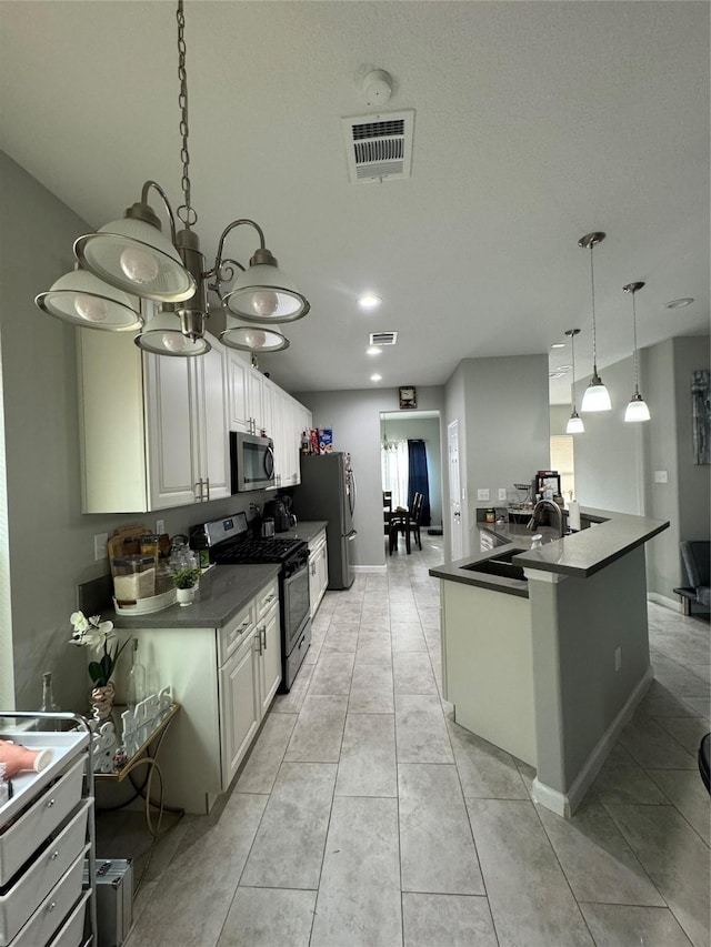 kitchen featuring sink, hanging light fixtures, light tile patterned floors, white cabinetry, and stainless steel appliances