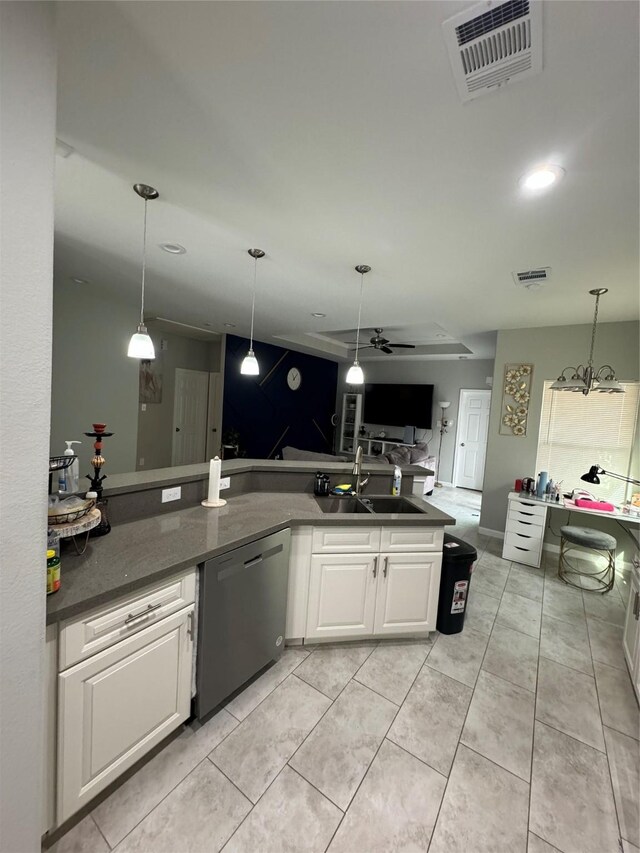 kitchen with white cabinets, stainless steel dishwasher, a sink, and visible vents