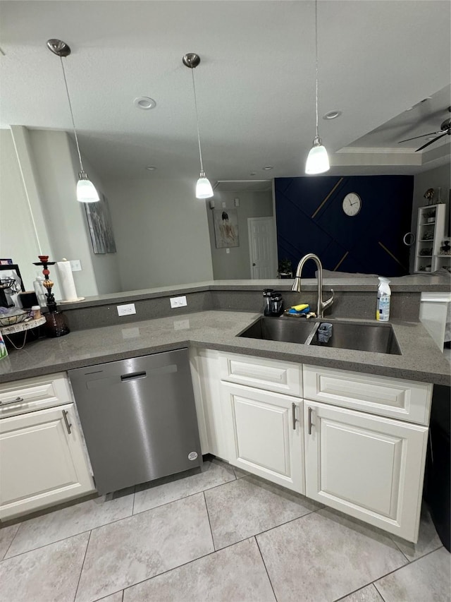 kitchen with a sink, white cabinetry, pendant lighting, stainless steel dishwasher, and light tile patterned flooring