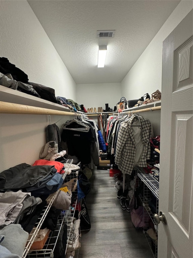 spacious closet with visible vents and wood finished floors