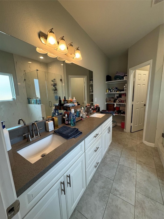 bathroom with vanity, tile patterned floors, and a shower with shower door