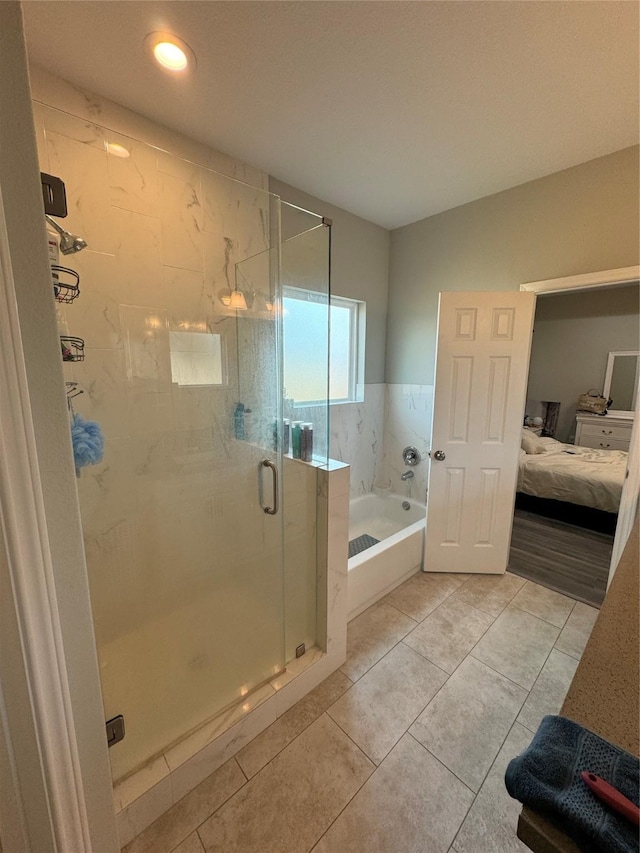 ensuite bathroom with ensuite bath, tile patterned flooring, a stall shower, and a garden tub