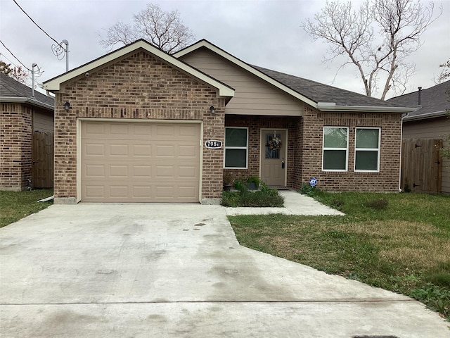 single story home with driveway, an attached garage, a front lawn, brick siding, and fence