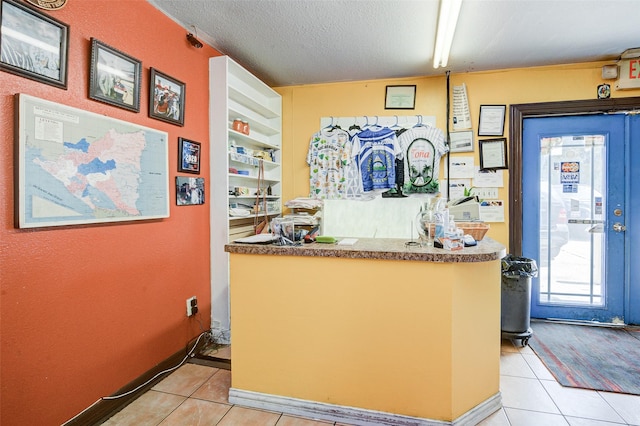 kitchen featuring light tile patterned floors and a textured ceiling