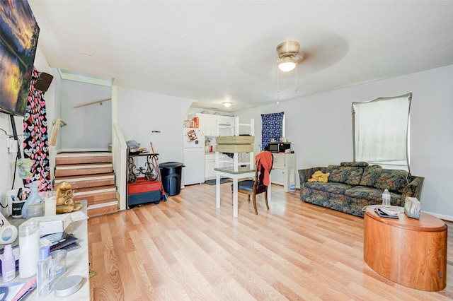 living room with ceiling fan and light wood-type flooring