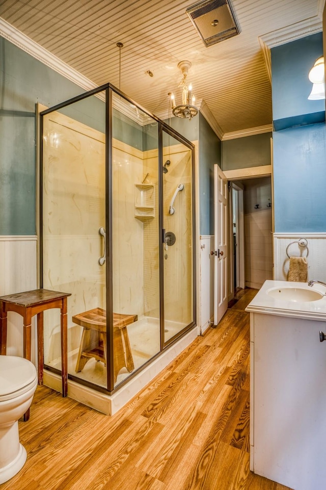 bathroom with an enclosed shower, wood ceiling, crown molding, wood-type flooring, and an inviting chandelier