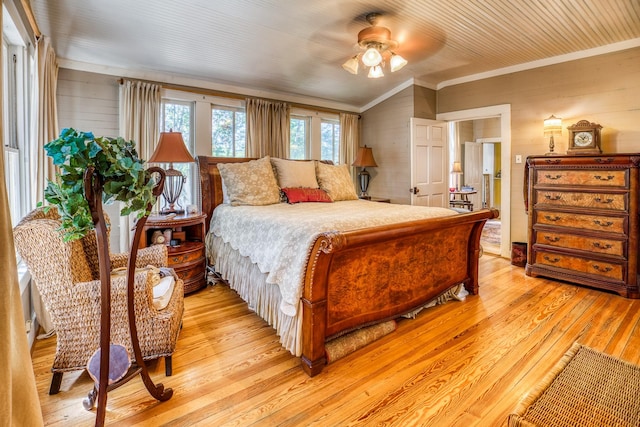 bedroom with light hardwood / wood-style flooring, ceiling fan, and ornamental molding