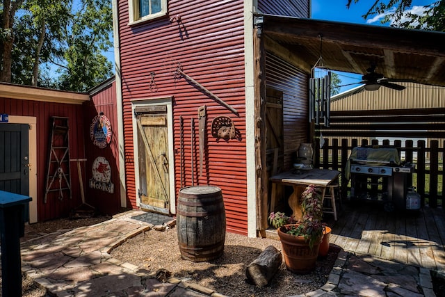 view of home's exterior with ceiling fan and a wooden deck