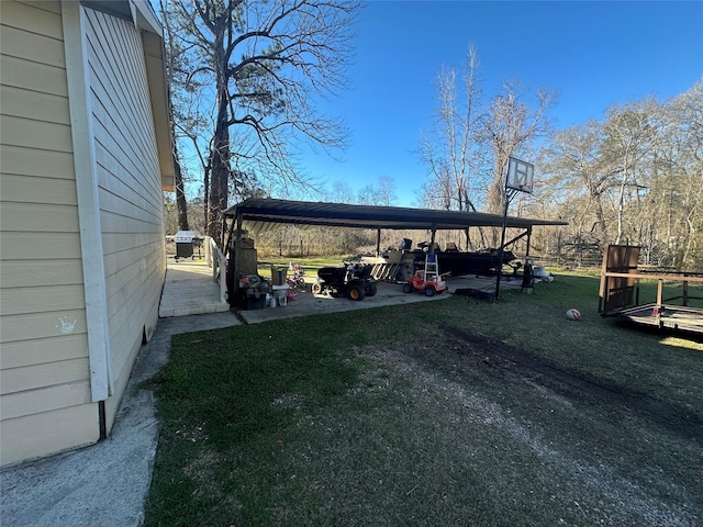 view of parking / parking lot featuring a yard and a carport