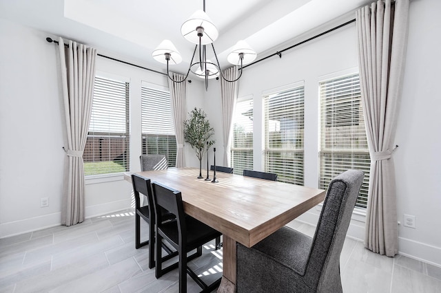 dining space featuring a notable chandelier and light tile patterned flooring