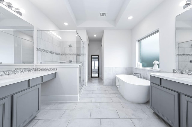 bathroom featuring tile patterned floors, vanity, and independent shower and bath