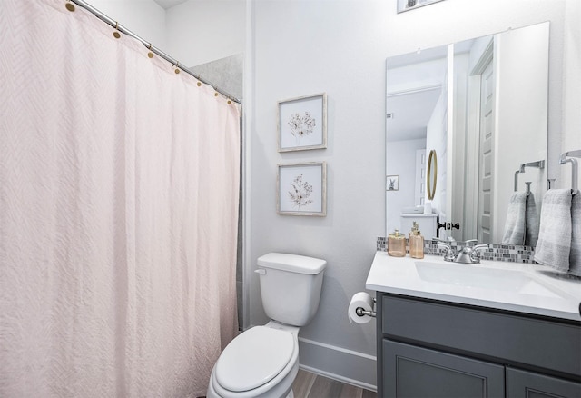 bathroom featuring vanity, wood-type flooring, and toilet