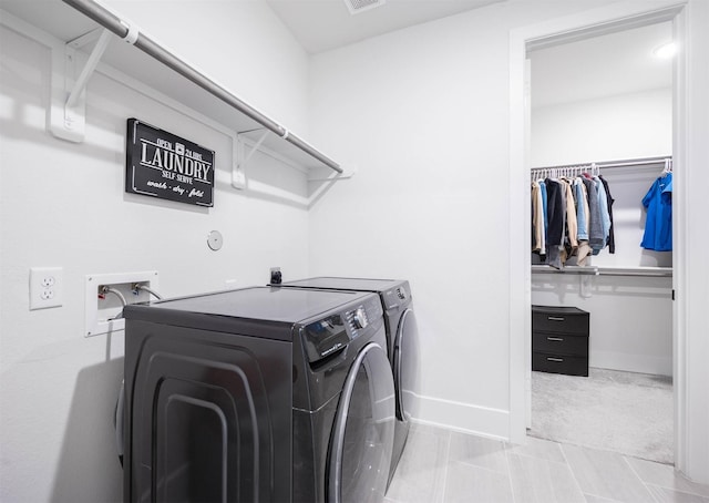 laundry area with independent washer and dryer