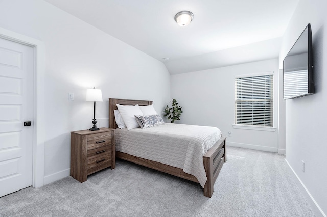 carpeted bedroom featuring vaulted ceiling