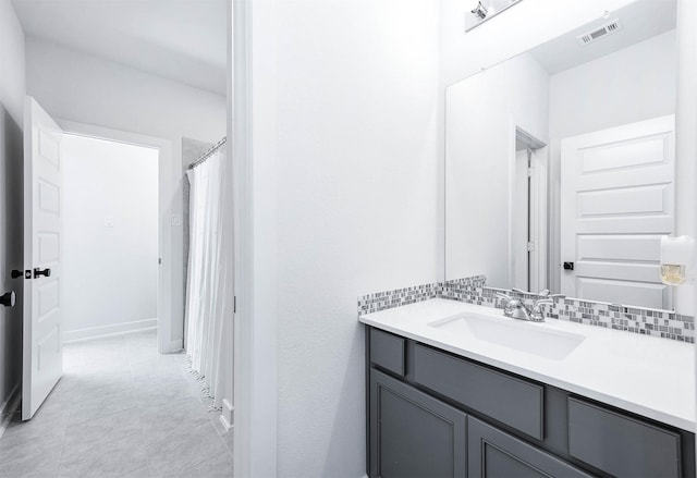 bathroom with tasteful backsplash and vanity