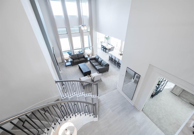 staircase with a healthy amount of sunlight and a high ceiling