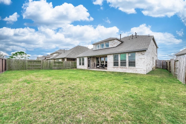 rear view of house featuring a patio area and a yard