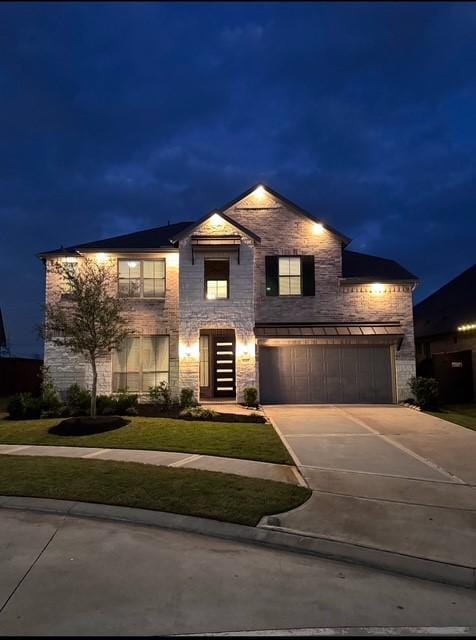 view of front of property with a lawn and a garage