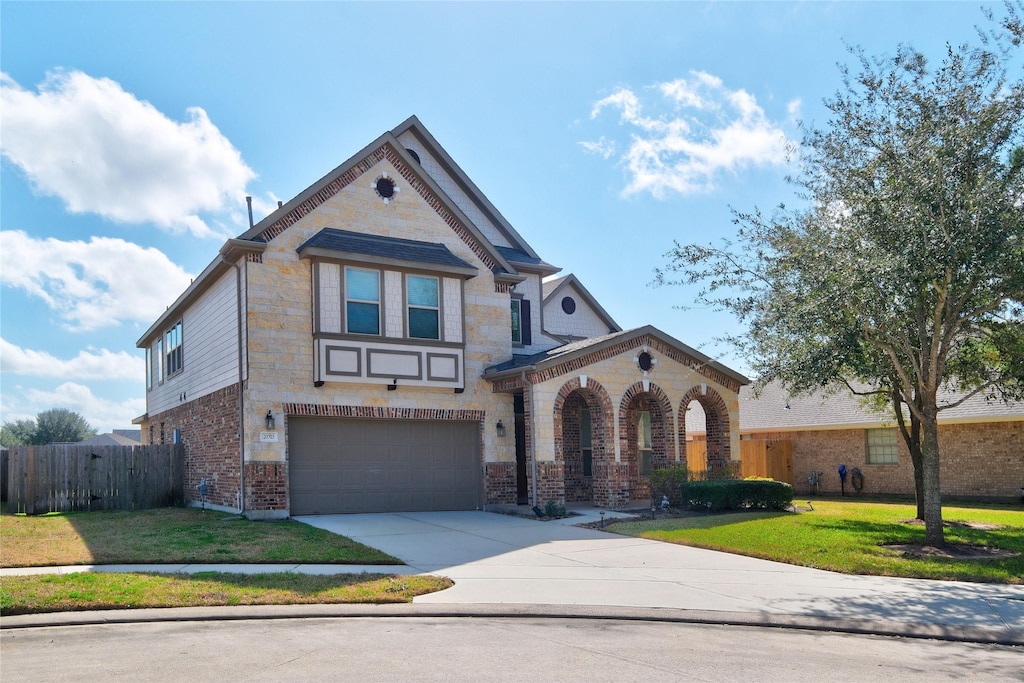 view of front facade with a garage and a front lawn