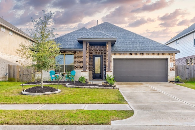 view of front of house with a lawn and a garage