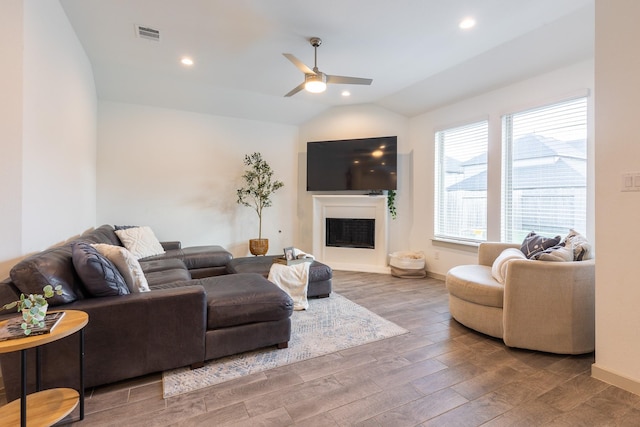 living room with ceiling fan and lofted ceiling