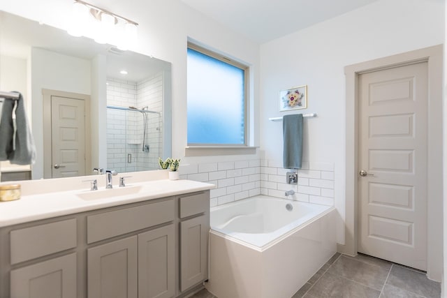 bathroom featuring tile patterned flooring, vanity, and separate shower and tub