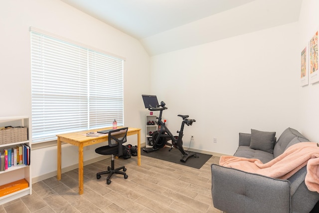 office area featuring light hardwood / wood-style flooring, a healthy amount of sunlight, and vaulted ceiling