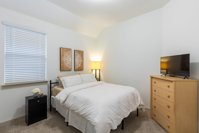 carpeted bedroom with lofted ceiling