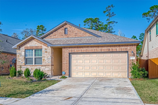 view of front facade featuring a shingled roof, stone siding, brick siding, and driveway