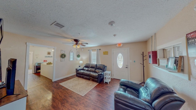 living room with ceiling fan, a textured ceiling, and hardwood / wood-style flooring