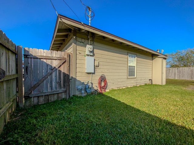 view of side of home featuring a yard