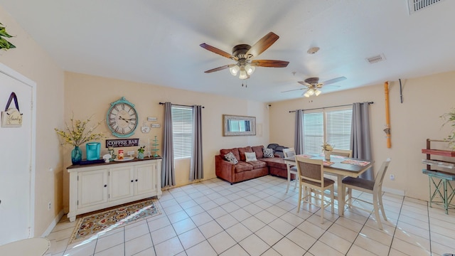 dining space with ceiling fan and light tile patterned floors