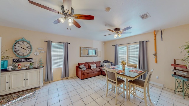 tiled dining area with ceiling fan