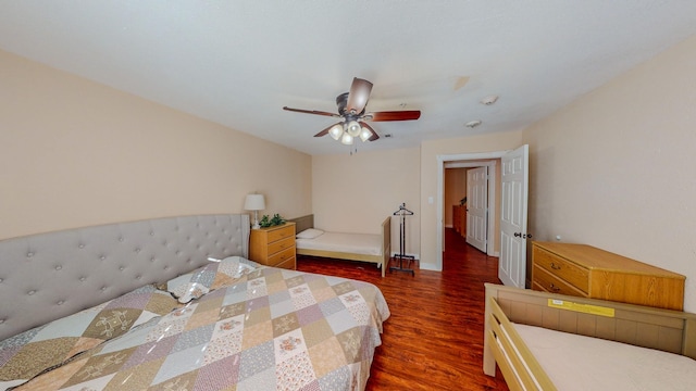 bedroom with ceiling fan and dark hardwood / wood-style flooring