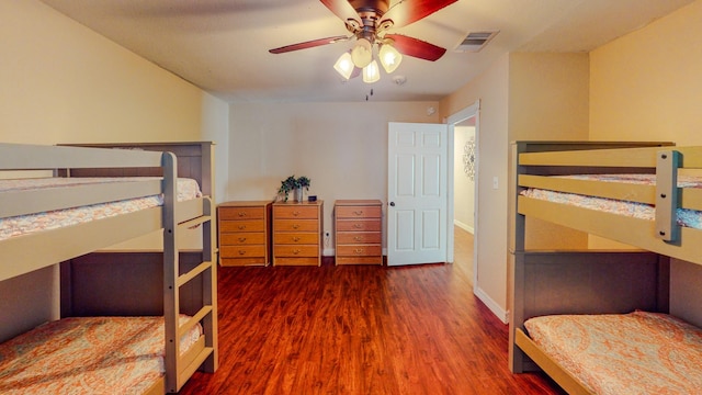 bedroom with ceiling fan and dark hardwood / wood-style floors