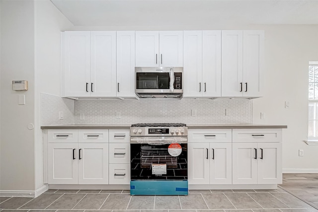 kitchen featuring stainless steel appliances and white cabinetry