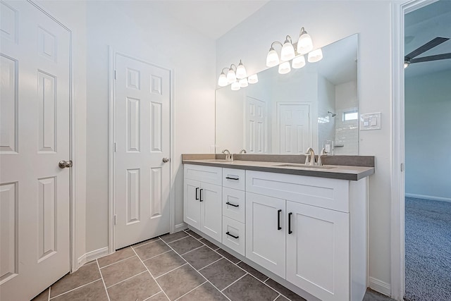 bathroom featuring a shower, ceiling fan, tile patterned flooring, and vanity