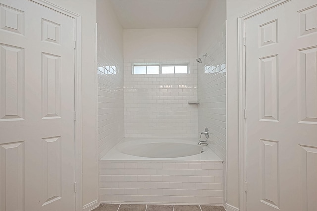 bathroom with tile patterned flooring and tiled shower / bath