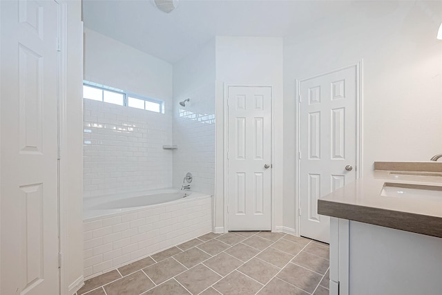 bathroom with tile patterned floors, tiled shower / bath combo, and vanity