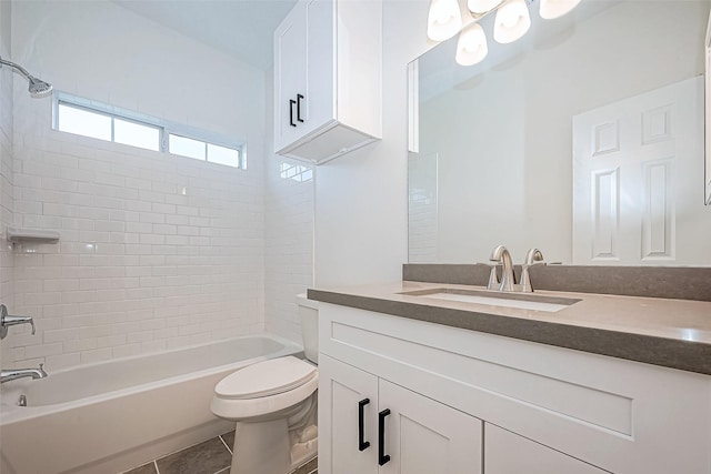 full bathroom with tile patterned flooring, vanity, toilet, and tiled shower / bath