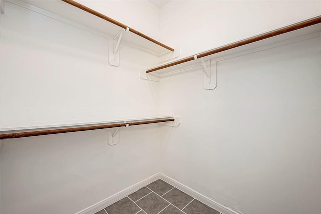 spacious closet with tile patterned floors