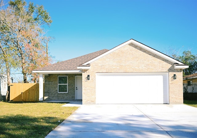 ranch-style house featuring a front yard and a garage