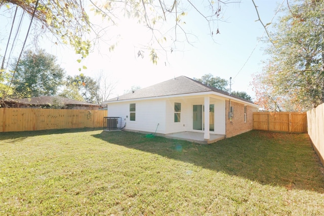 back of property featuring a patio area, a yard, and cooling unit